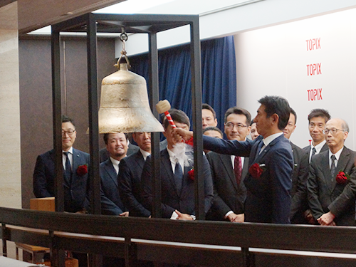 上場のセレモニーで鐘を鳴らす松下社長（写真中央）